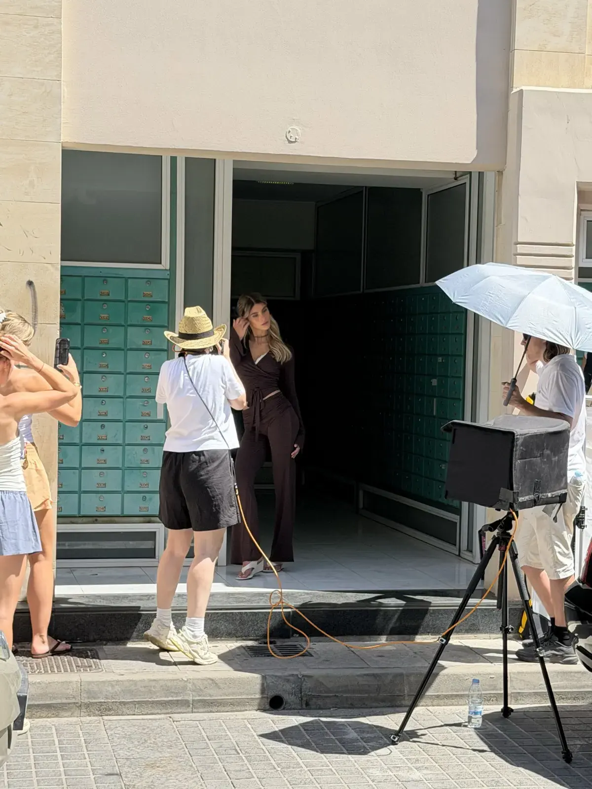 Crew, monitor, and umbrella at the doorway